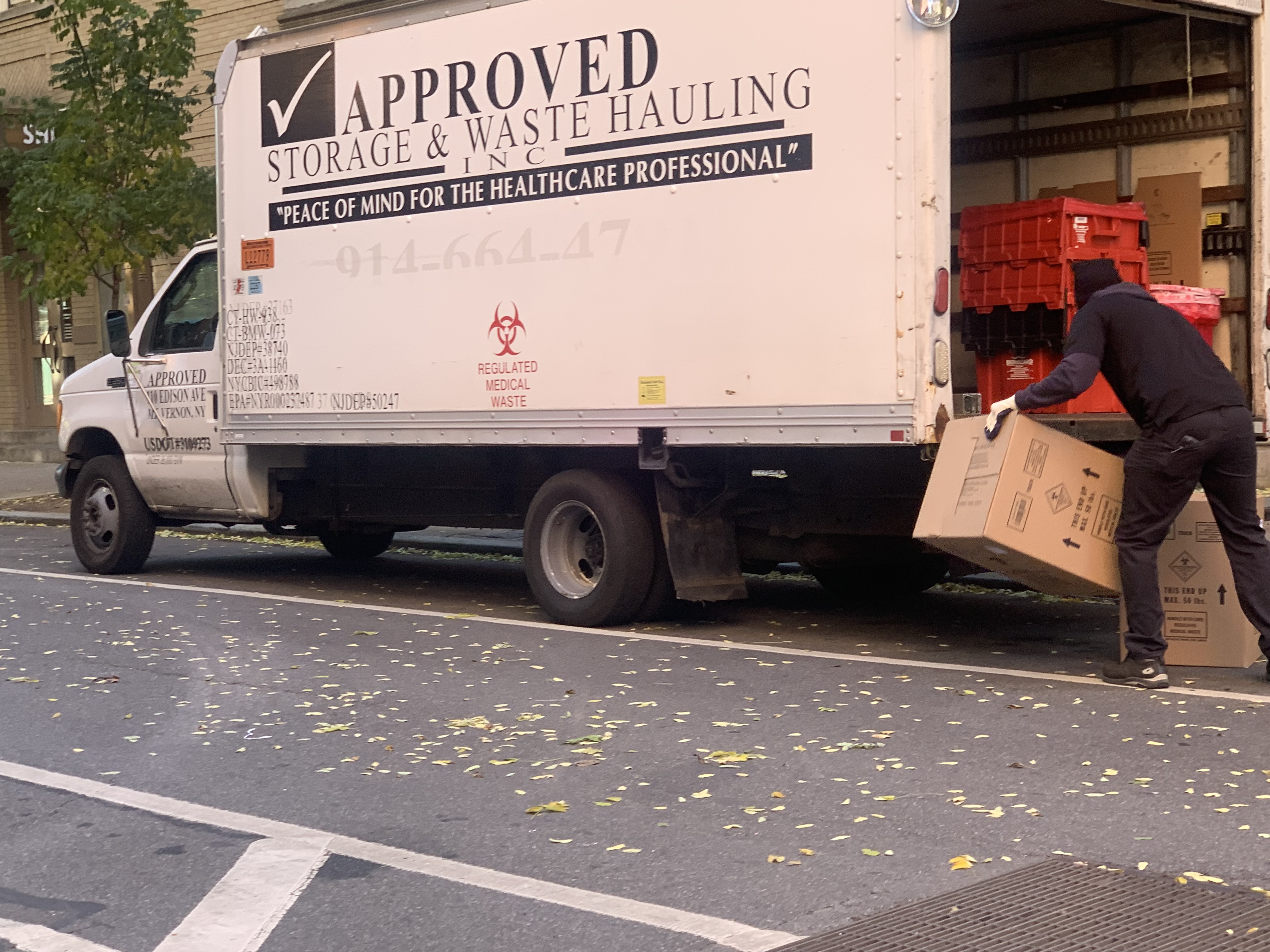 Picking up a dropped box of "medical waste" leaving Manhattan's Planned Parenthood on the afternoon of Dec. 3, 2021