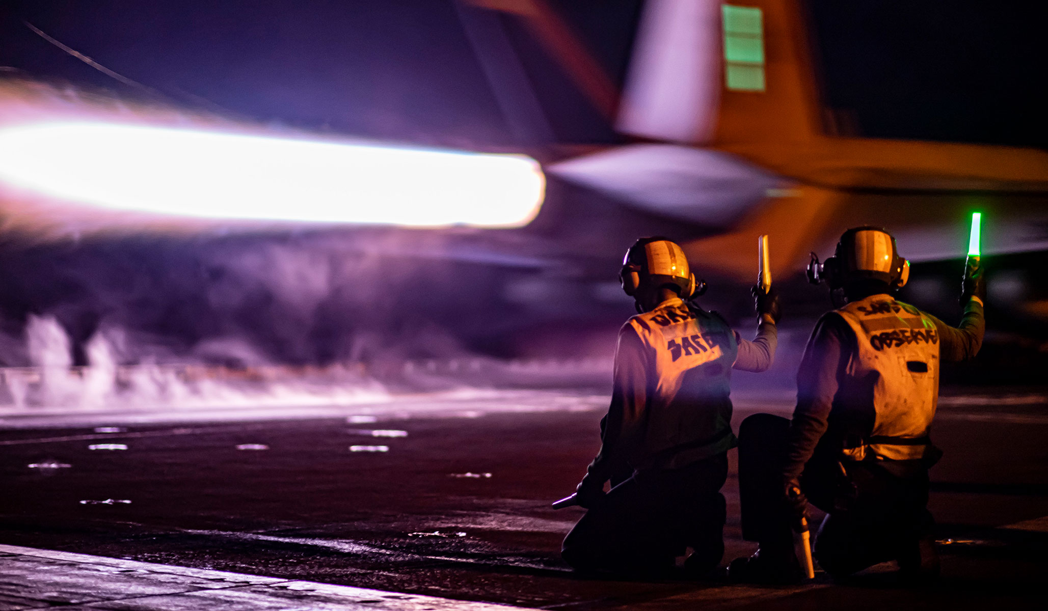 Sailors observe the launch an F/A-18E Super Hornet from the “Kestrels” of Strike Fighter Squadron VFA-137 from the flight deck of the aircraft carrier USS <i>Nimitz</i> (CVN-68), under way in the Philippine Sea, January 7, 2023. 